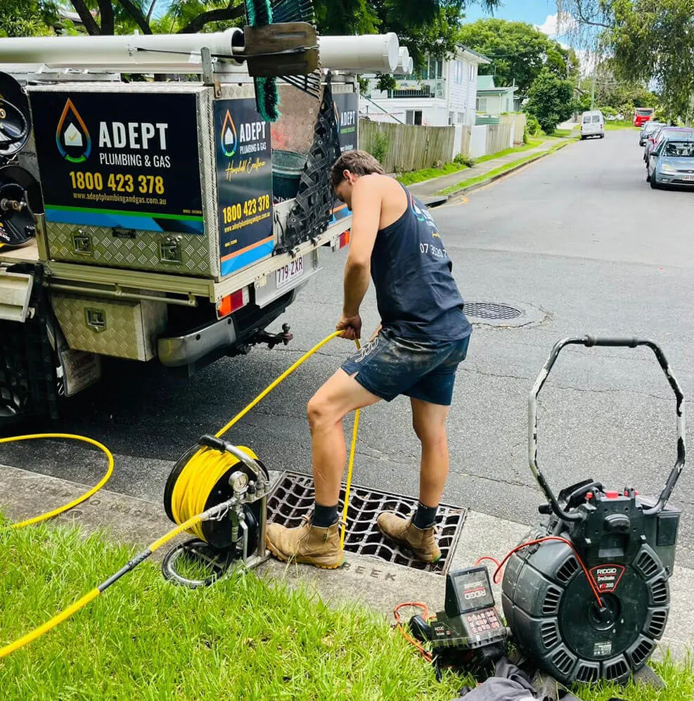 Adept Plumbing & Gas plumber performing drain cleaning with jet rodding equipment in Logan