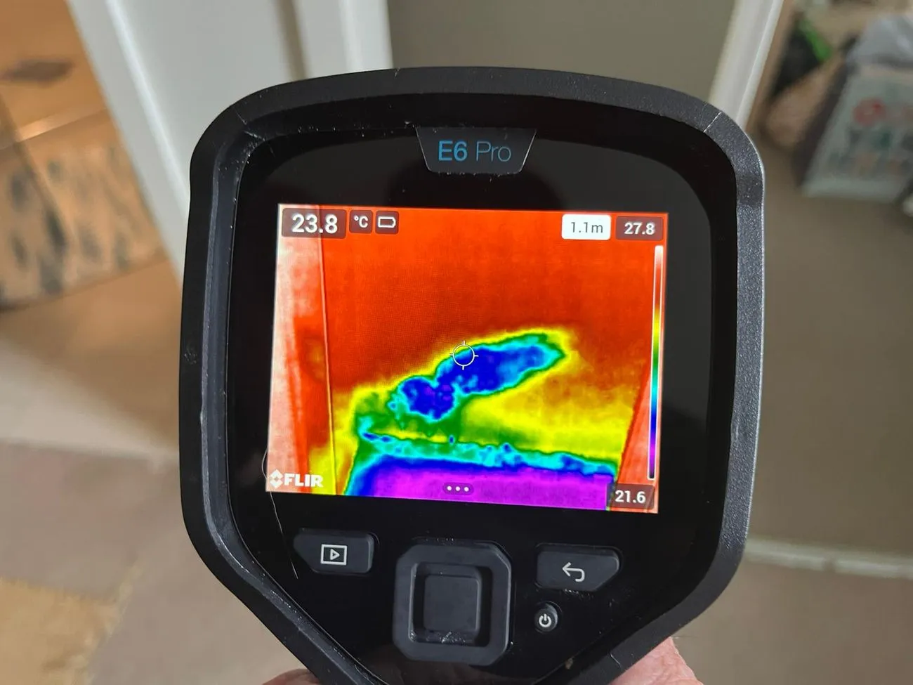 Thermal imaging camera detecting hidden water leaks behind walls, showcasing advanced plumbing inspection technology