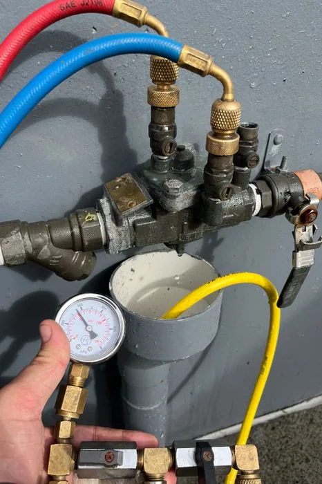 Backflow prevention device connected to a test kit and pressure gauge