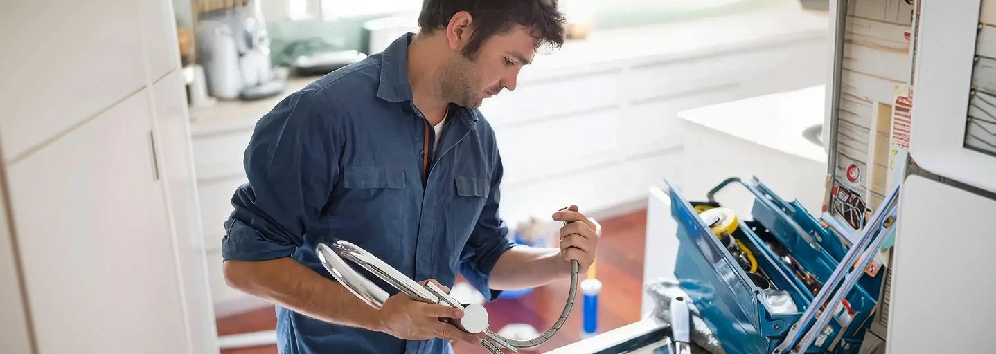 Plumber checking a kitchen mixer tap