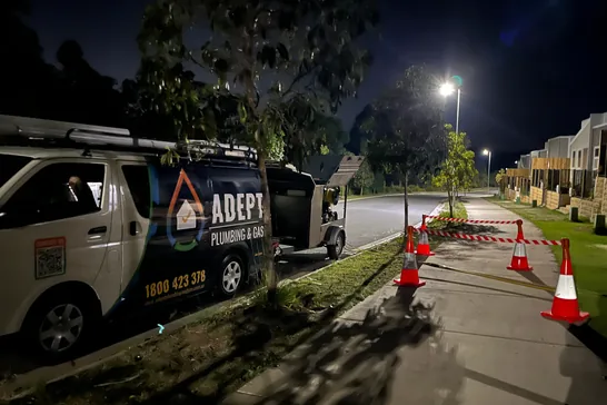 Adept Plumbing & Gas van on an after-hours emergency call-out with safety cones set up