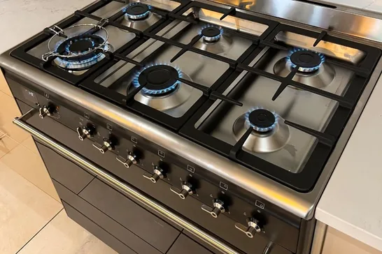Freestanding gas cooktop with all burners lit after installation