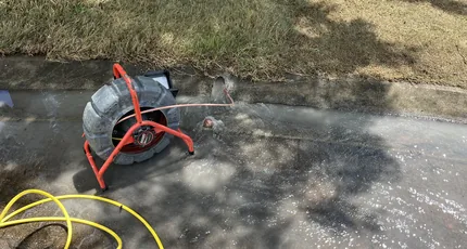 Drain jetting hose feeding into a street drain in Calamvale