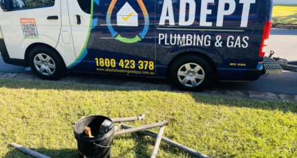 Adept Plumbing & Gas van parked beside drain clearing equipment on a Camp Hill lawn