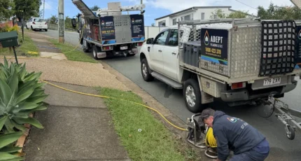Plumber running the drain jetter from the ute on a Cornubia street