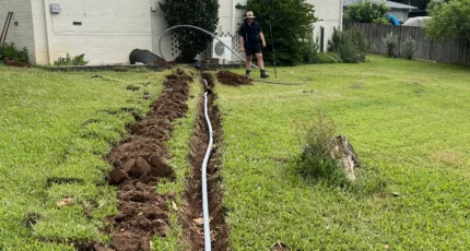 New pipework laid in a trench across a Daisy Hill front yard