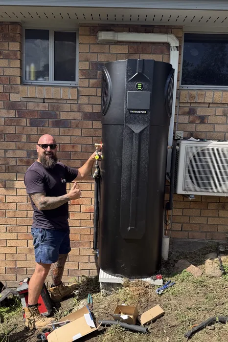 Adept Plumbing & Gas plumber installing a heat pump hot water system in Rochedale