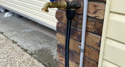 Outdoor tap and pipework fitted to a brick wall in Tanah Merah