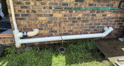 New external PVC pipework fitted to a brick wall in Tanah Merah