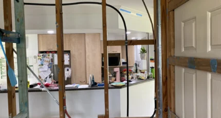 Plumbing rough-in through wall framing in Tanah Merah