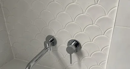 Wall-mounted bath spout and mixer above a new bath in Tarragindi