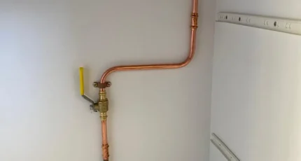 New copper gas line with a yellow isolation valve installed inside a meter box