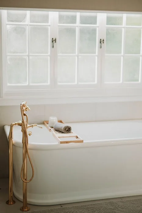 Freestanding bath with brass floor-mounted tapware in Camp Hill