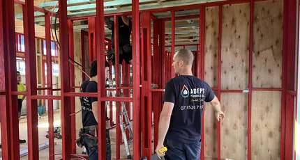 Plumbers roughing in pipework through a renovation frame in Camp Hill