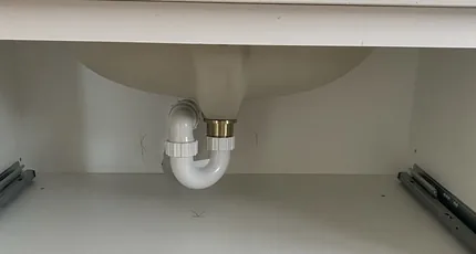 Chrome basin waste installed under a vanity in Carina