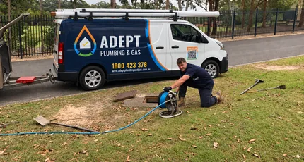 Adept Plumbing & Gas plumber with a drain jetter beside the service van in Daisy Hill