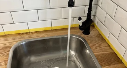 Kitchen sink and black mixer tap installed in Greenslopes
