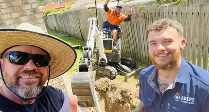 Adept Plumbing & Gas crew with a mini excavator on a Kingston drainage job