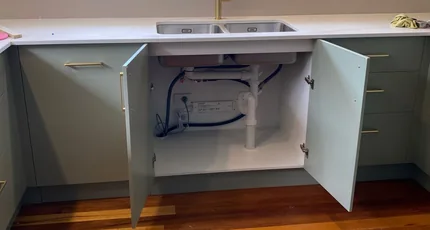 New kitchen sink and under-sink plumbing in a Kingston home