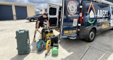 Plumber unloading leak detection equipment from the van in Kingston