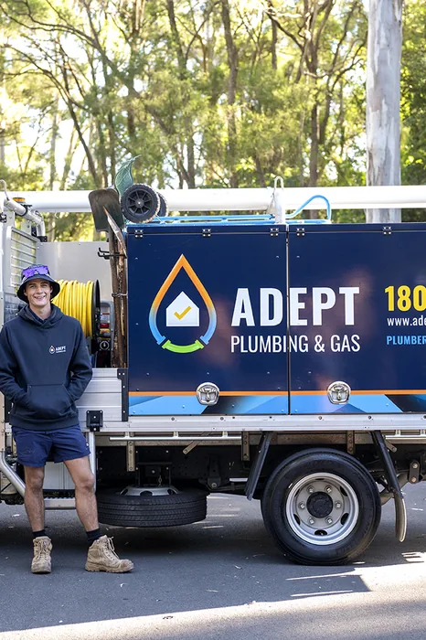 Adept Plumbing & Gas plumber beside the company jetting truck in Kingston