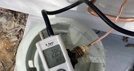 Water pressure test gauge on pipework in Kingston