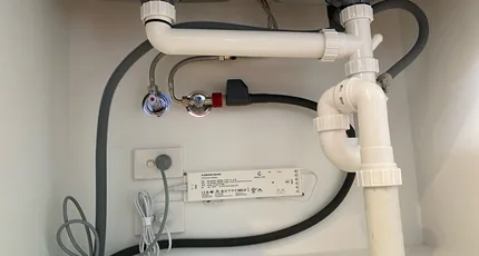 Under-sink waste and water connections in a Kingston kitchen