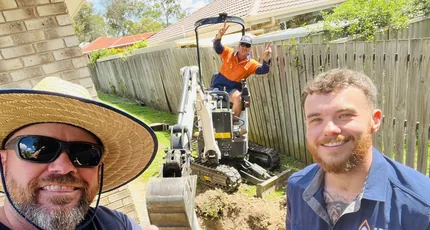 Adept Plumbing & Gas plumbers with a mini excavator on a drainage job in Logan