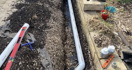 New stormwater pipe laid in a garden trench in Logan