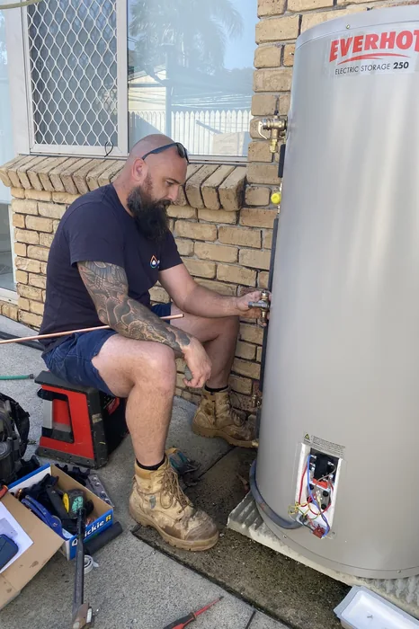 Plumber installing an Everhot electric hot water system in Loganholme