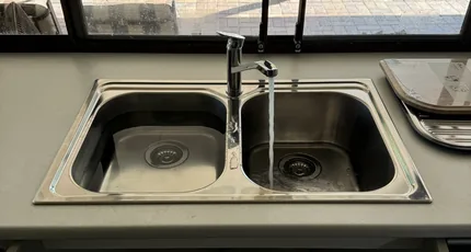 Stainless double kitchen sink and mixer in a Loganholme home