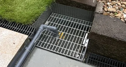New grated stormwater drain installed in a garden in Marsden