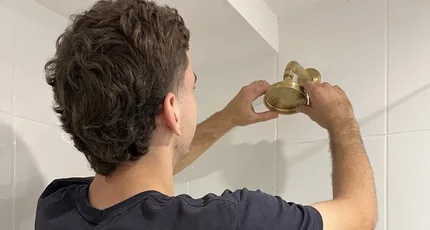 Plumber fitting a shower outlet during a bathroom rough-in in Marsden