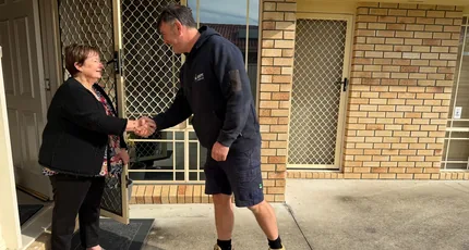 Adept Plumbing & Gas plumber shaking hands with a customer at her front door in Meadowbrook