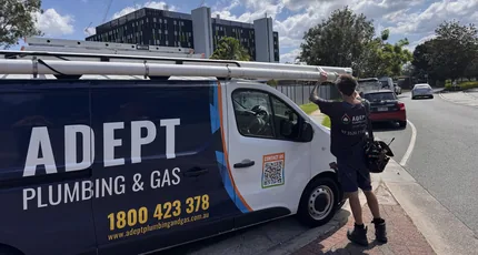 Adept Plumbing & Gas plumber at the service van on a Meadowbrook street