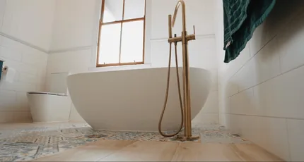 Freestanding bath with a floor-mounted brass mixer in New Farm