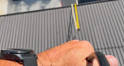 Plumber inspecting pipework on a New Farm roof