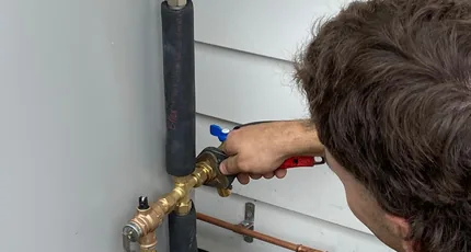 Adept Plumbing & Gas plumber fitting copper pipework at a meter in Rochedale