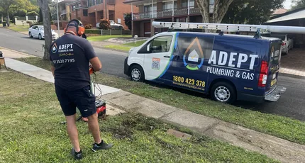 Adept Plumbing & Gas plumber locating a pipe beside the service van in Rochedale