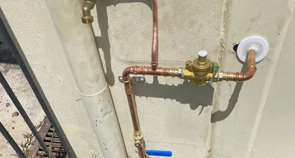 External copper pipework and water meter on a Shailer Park home