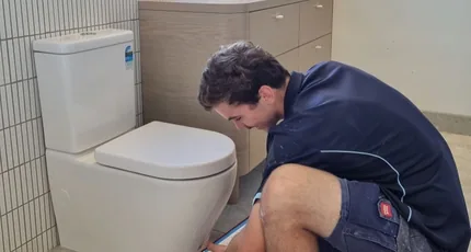 Plumber installing a new toilet in Springwood