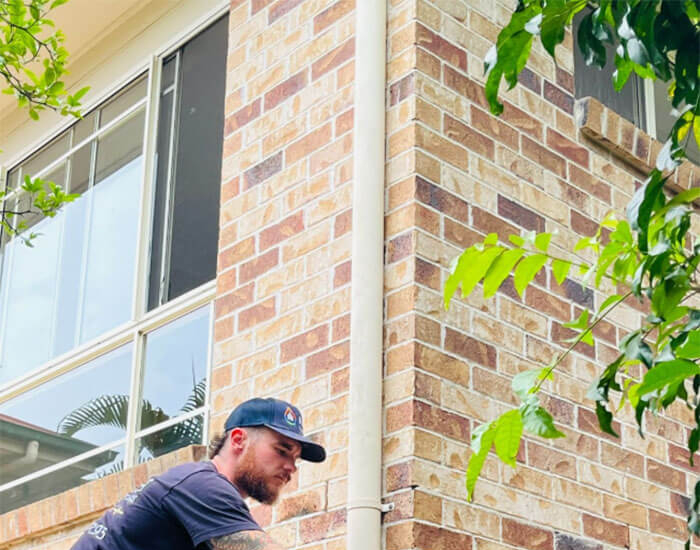 Plumber in Logan using a CCTV camera to inspect a blocked drain