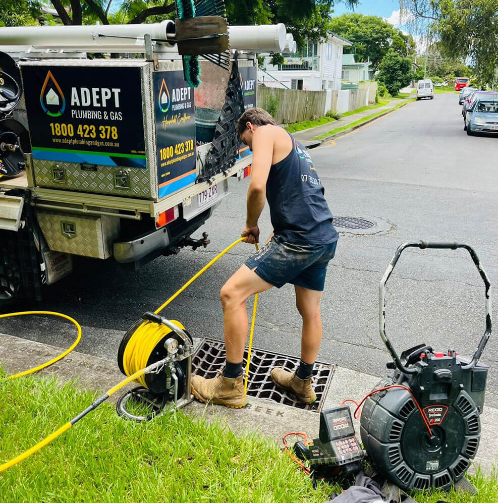 Adept Plumbing & Gas plumber performing drain cleaning with jet rodding equipment in Logan