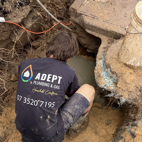 Alt text: Emergency plumber from Adept Plumbing & Gas working on site in Logan, repairing leaking pipes