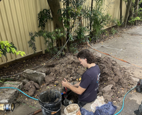 Your Local Emergency plumber at Adept repairing leaking pipes in Logan home