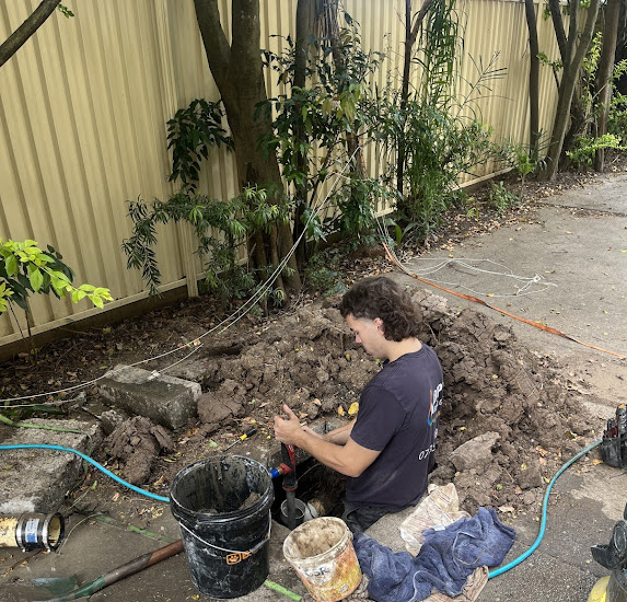 Your Local Emergency plumber at Adept repairing leaking pipes in Logan home