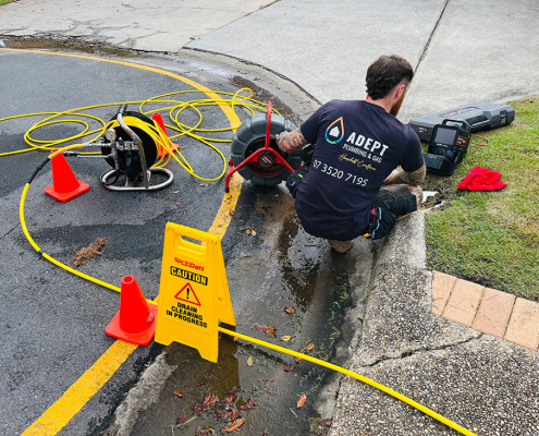 Adept Plumbing & Gas expert plumber working on blocked stormwater drains in Logan