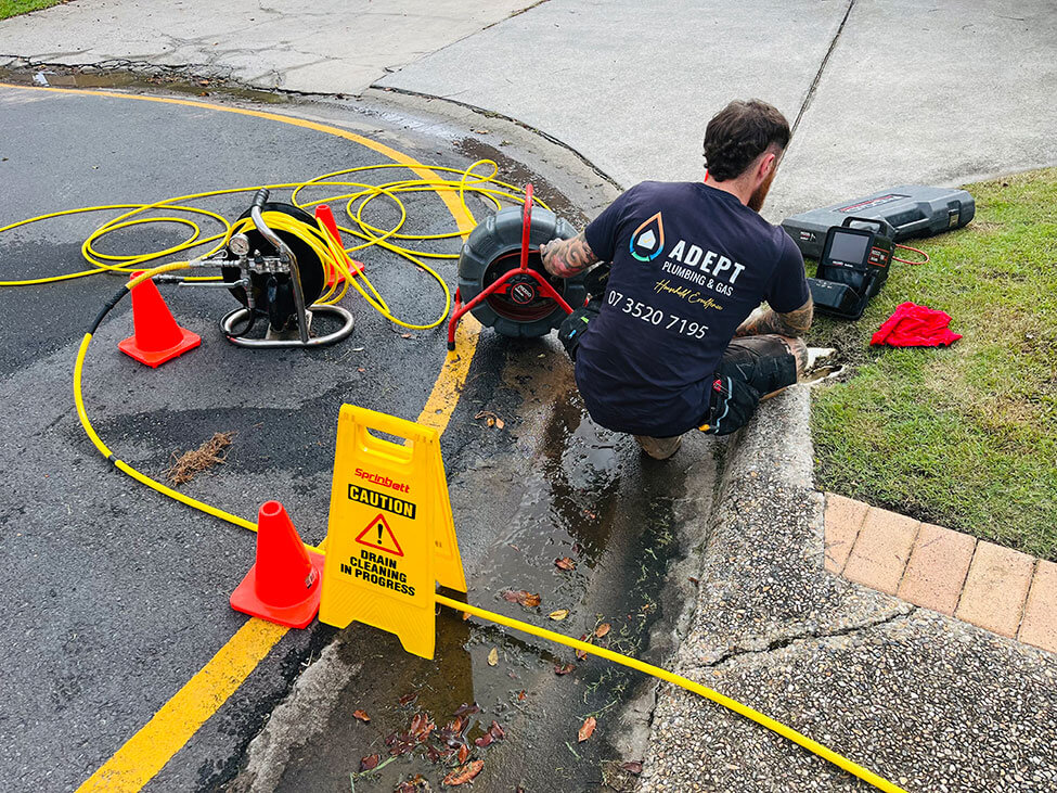 Adept Plumbing & Gas expert plumber working on blocked stormwater drains in Logan